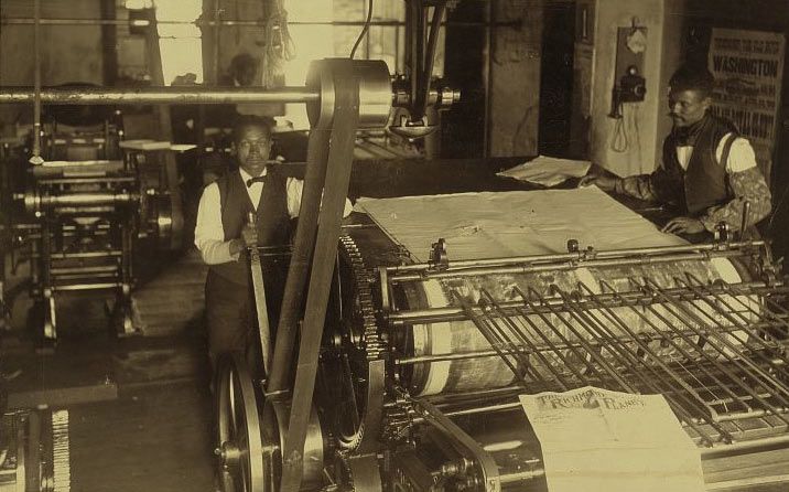 Black printers at a printing press in 1899