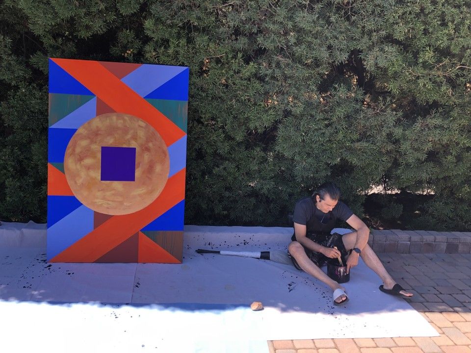 Photo of John Couch next to his painting