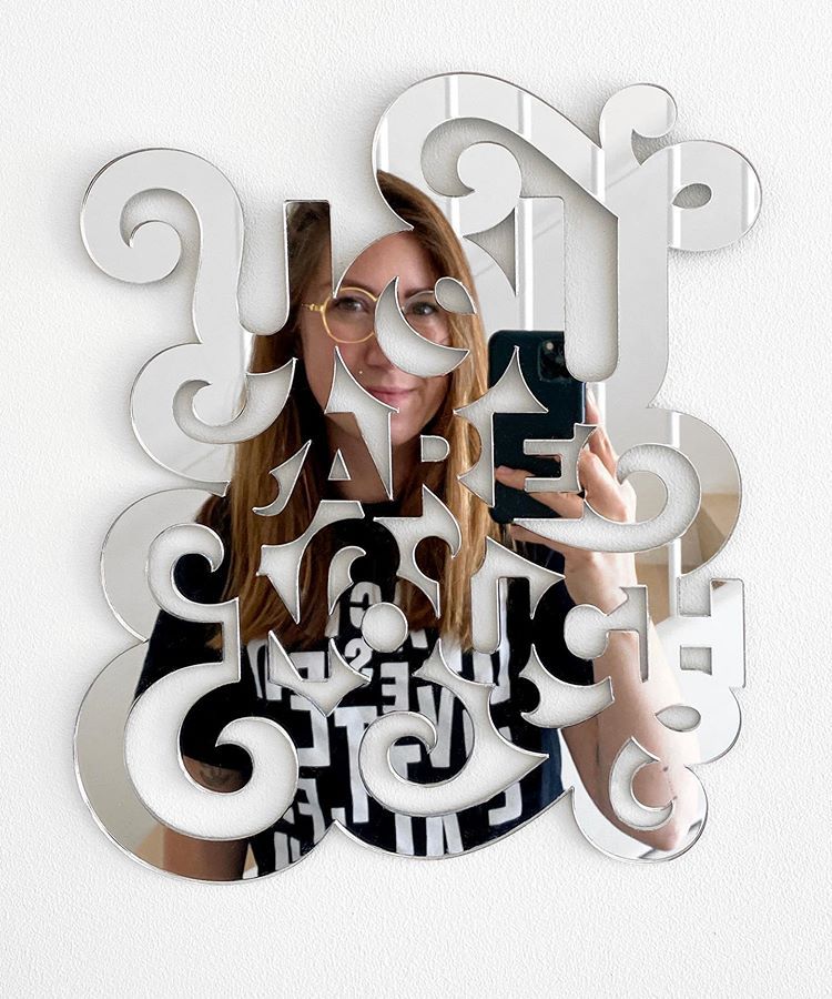 Mirror in the shape of lettering that says “You are enough”